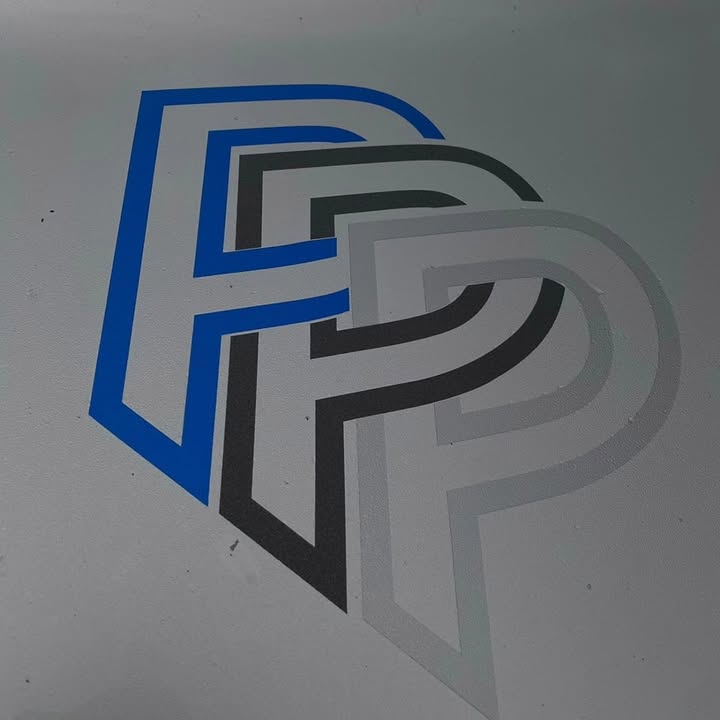 The Phill Page and Sons three-P mark painted on the wall of their Hyde yard — three overlapping P shapes in cobalt blue, charcoal, and silver.